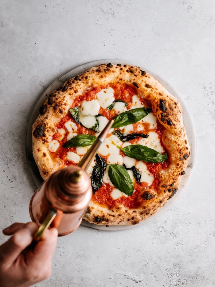 Delicious Italian pizza topped with mozzarella, basil, and olive oil. A classic culinary delight.